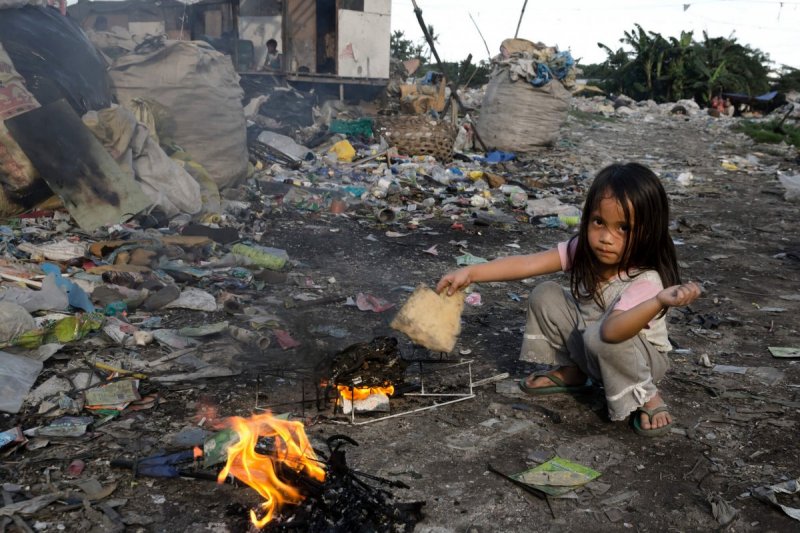 Ein Mädchen verbrennt Müll